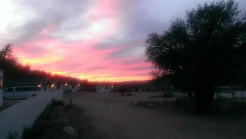 Pink sunset over the road running through the ranch